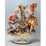 A 20th Century Italian Capodimonte style ceramic figurine depicting a boy and a girl next to a