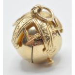 A hallmarked 9ct gold Masonic ball pendant opening to reveal pyramids with engraved symbols