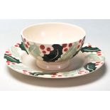 A late 20th Century ceramic tea cup and saucer by Emma Bridgewater in the Holly pattern decorated in