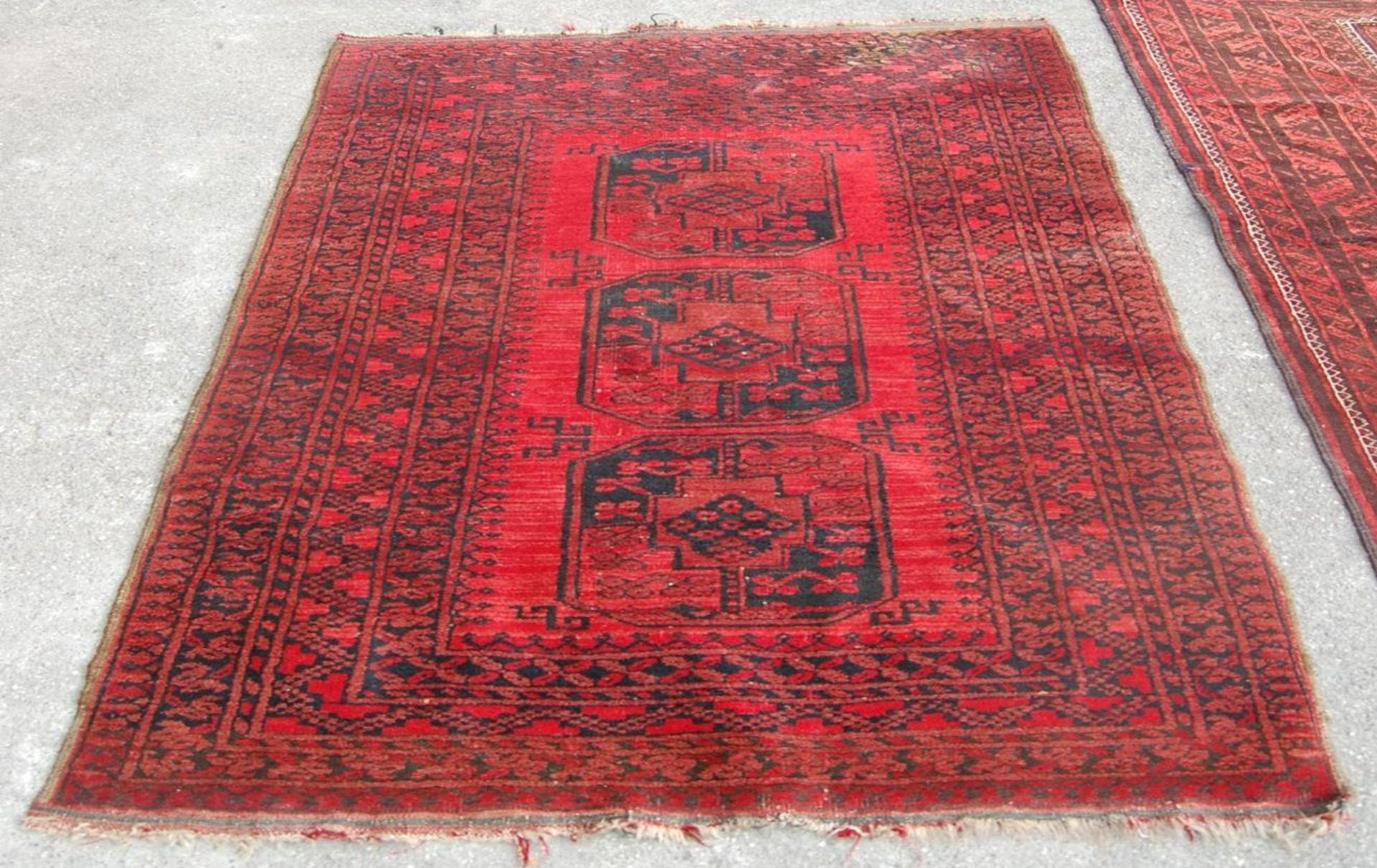 A pair of Islamic / Persian carpet rugs comprising of a red and black carpet having three - Image 2 of 9