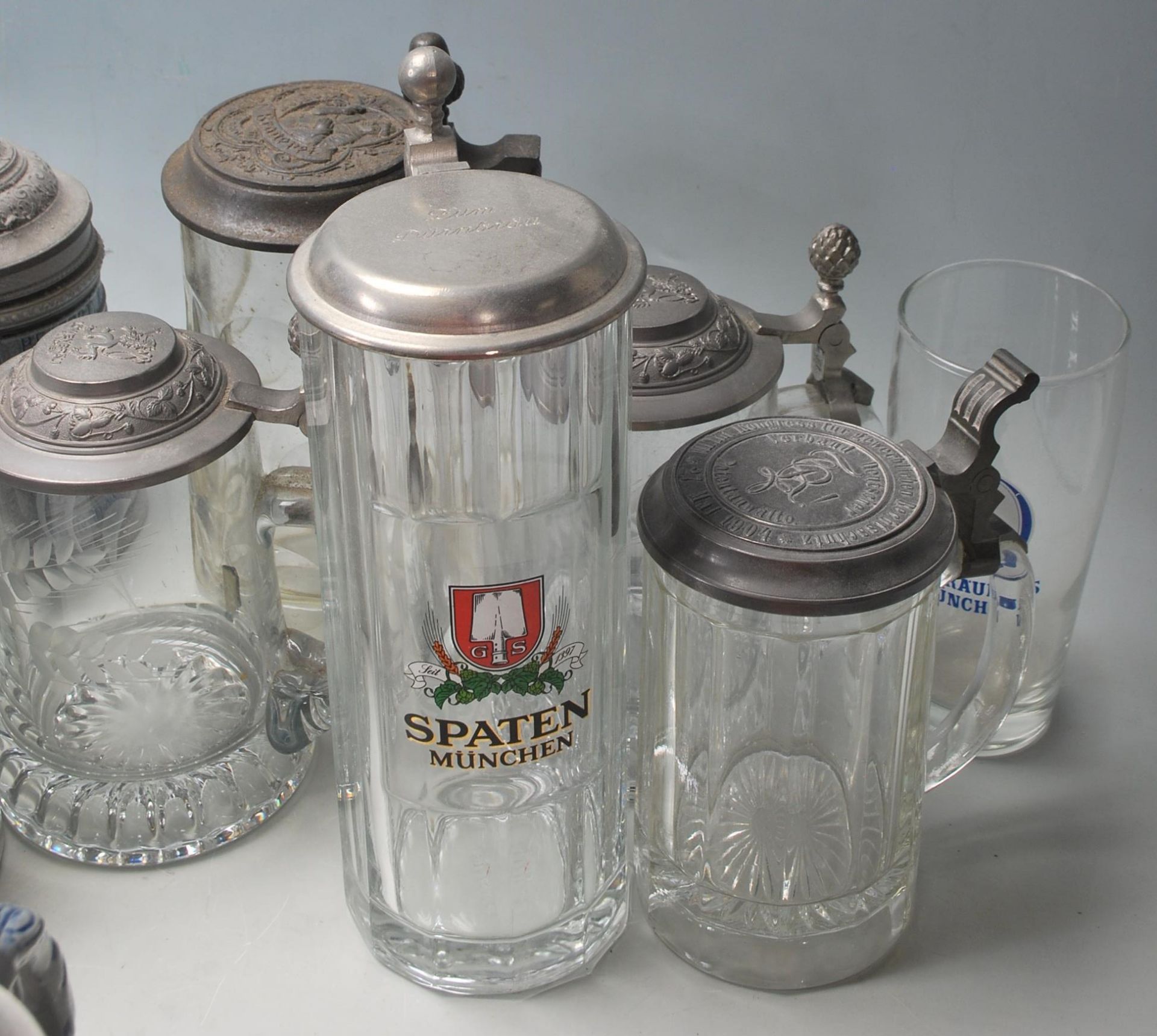 A collection of 20th Century German ceramic stein drinking glasses, each having raised decoration to - Bild 8 aus 10