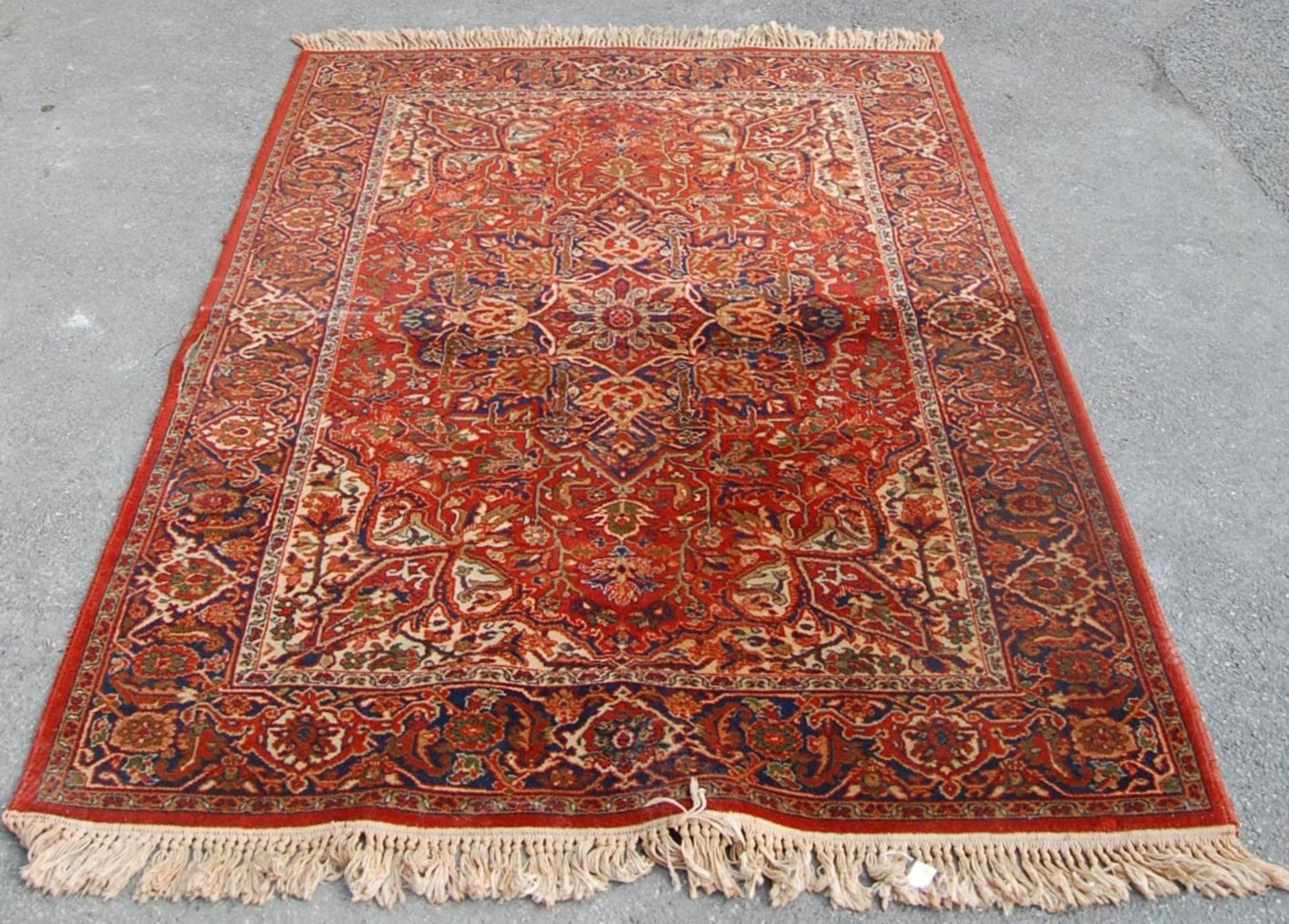 A 20th century Persian / Islamic Mashad Iranian floor rug having a central red ground with single