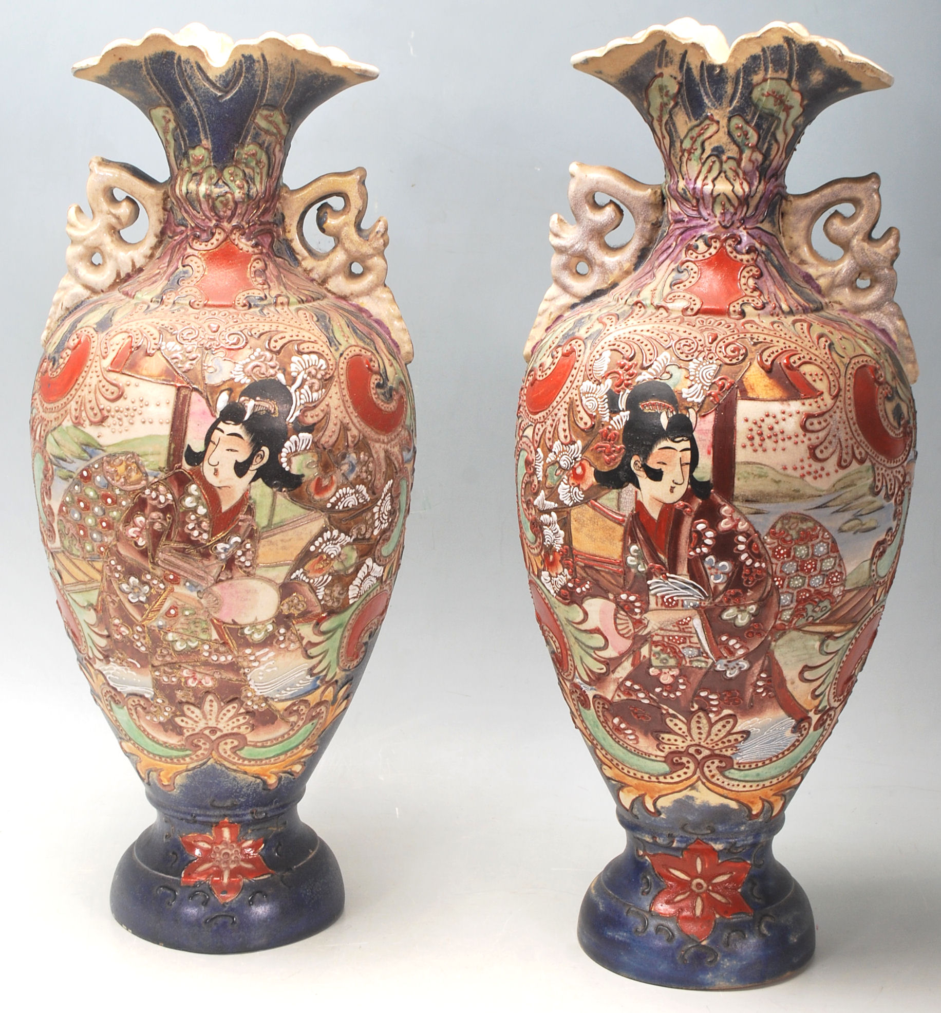A pair of 20th Century Meiji revival Japanese vases having a flared top over a shaped body on a
