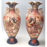 A pair of 20th Century Meiji revival Japanese vases having a flared top over a shaped body on a