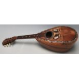 An early 20th Century Stridente Italian olive wood mandolin instrument having an oval soundhole with