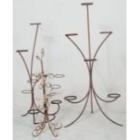 A pair of vintage 20th century retro blacksmith iron florist plant stands being made of metal band