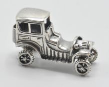 A silver 925 figure of a classic car with spinning