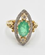 A hallmarked 18ct gold emerald and diamond ring. T