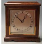 An mid century 1960s Oak mantle clock having a ped