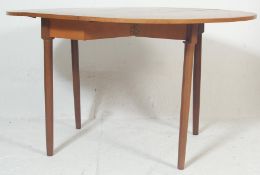 A retro vintage 1970s teak wood drop leaf dining t