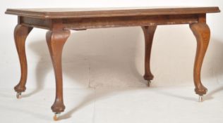 An Edwardian early 20th century oak draw leaf extending dining table and chairs complete with two