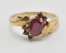 A vintage 9ct gold and ruby crossover cluster ring