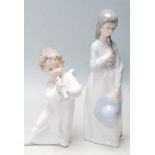 Two 20th century ceramic porcelain figurines to include a Lladro A540 figurine of a angel playing