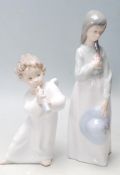 Two 20th century ceramic porcelain figurines to include a Lladro A540 figurine of a angel playing