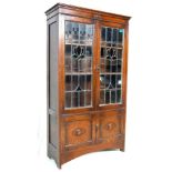 A 1920’S OAK CABINET WITH STAINED GLASS.