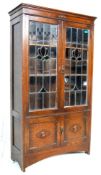A 1920’S OAK CABINET WITH STAINED GLASS.
