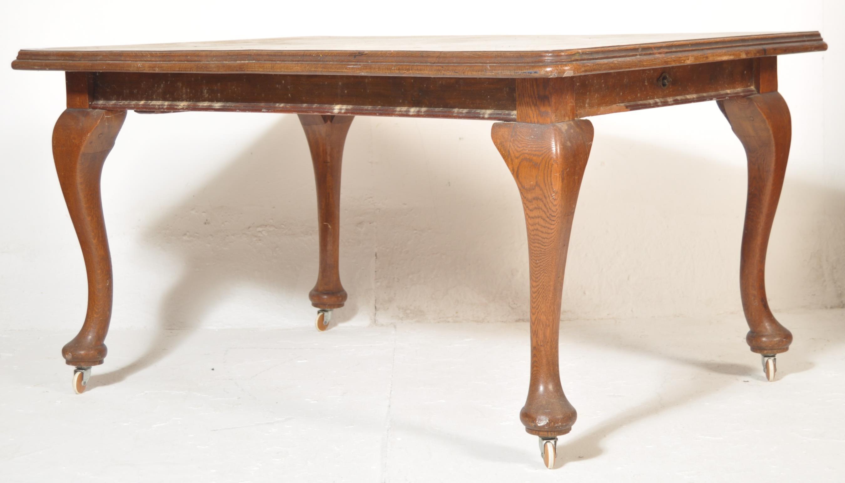 An Edwardian early 20th century oak draw leaf extending dining table and chairs complete with two - Image 4 of 5