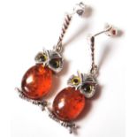 A PAIR OF STAMPED 925 SILVER EARRINGS SET WITH AMBER STYLE STONES IN THE FORM OF OWLS
