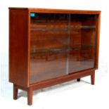 A 1970's retro vintage oak sideboard credenza / display cabinet having large glazed sliding doors