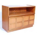 A vintage 1970’s teak wood Nathan low sideboard having raised ends, open cupboard atop and twin