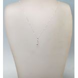 A STAMPED 18K WHITE GOLD PENDANT NECKLACE WITH A THREE STONE DIAMOND DROP.