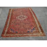 A LARGE ANTIQUE STYLE PERSIAN RUG