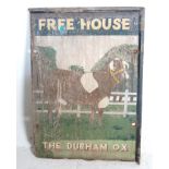 A vintage early 20th century Free House board wooden pub sign with a brown cow painted to the