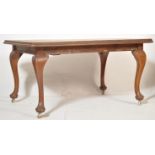 An Edwardian early 20th century oak draw leaf extending dining table and chairs complete with two
