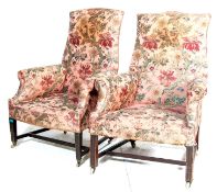 A pair of 19th century Victorian armchairs having oak squared tapered supports united by