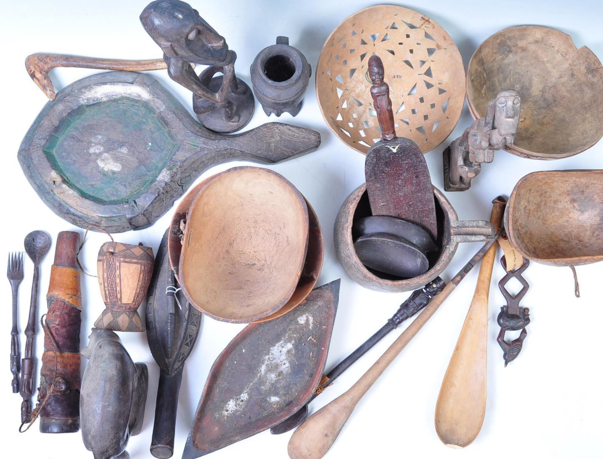 A large quantity of early 20th century mixed tribal wooden traditional items / ware to include,