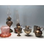 A pair of antique Victorian brass and copper oil lamps with glass funnel along with other brass ware