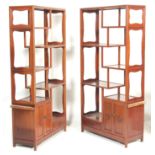 A pair of Chinese republic hardwood upright room divider / bookcases having a staggered shelving