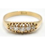 A stamped 18ct gold ring set with five graduating round cut white stones. Band stamped 18ct.