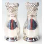 A SILVER PLATED CRUET SET IN THE FORM OF A PAIR OF DOGS