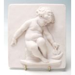 A 20th century square Composition Relief Moulded Plaque, decorated with Putti style children playing