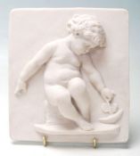 A 20th century square Composition Relief Moulded Plaque, decorated with Putti style children playing