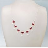 A STAMPED 925 SILVER GARNET AND FRESHWATER PEARL NECKLACE