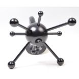 A retro vintage industrial atomic revolving monochrome coat hanger having a central sphere with coat