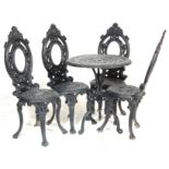 A VINTAGE 20TH CENTURY GARDEN SET COMPRISING OF A CIRCULAR TABLE AND FOUR CHAIRS