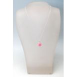 A STAMPED 925 SILVER PENDANT NECKLACE SET WITH A PINK STONE.