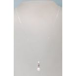 A STAMPED 9CT WHITE GOLD PENDANT NECKLACE HAVING A DIAMOND AND PEARL DROP.