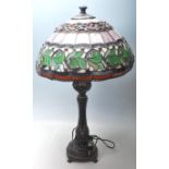 A Tiffany style table lamp having a leaded stained glass shade with blue glass panels and glass