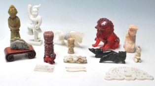 A collection of early and late 20th century Chinese oriental stone statues figurines depicting