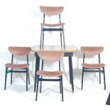 A vintage retro 1980’s draw leaf dining table and four chairs. The table is having melamine top with