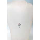 A STAMPED 925 SILVER CHERUBPENDANT NECKLACE WITH ENAMEL DETAILING, MARCASITES AND A TOPAZ DROP
