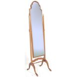An Edwardian mahogany cheval dressing mirror, set within upright frame wooden finials, dome top