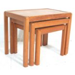 A vintage 1970’s teak wood graduating nest of tables having square supports with beveled edges.