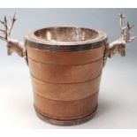 A SILVER PLATED AND WOODEN ICE BUCKET WITH STAG SHAPED HANDLES