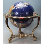 A vintage 20th century terrestrial globe having semi precious stone inlay. Black stone ground with