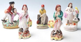 A group of five small Victorian Staffordshire hand painted ceramic figurines to include young